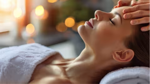 A Woman enjoying a relaxing head massage at a spa to unwind and rejuvenate.